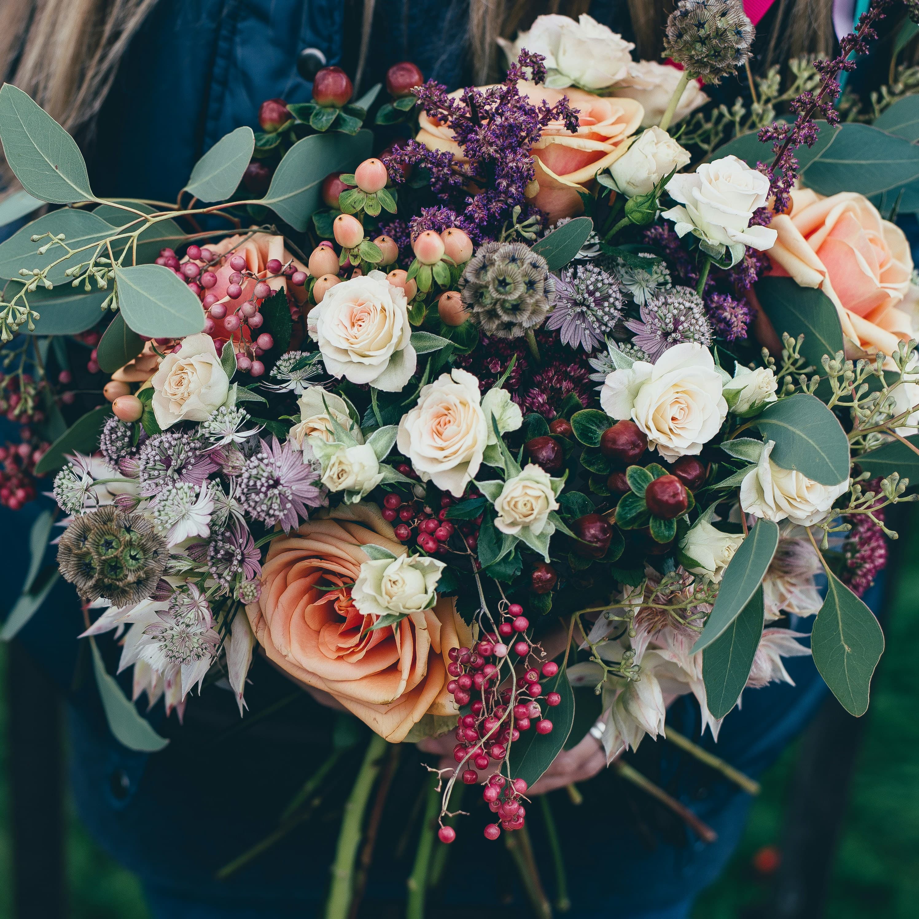 Warm bouquet of garden roses on a wooden surface, low afternoon light