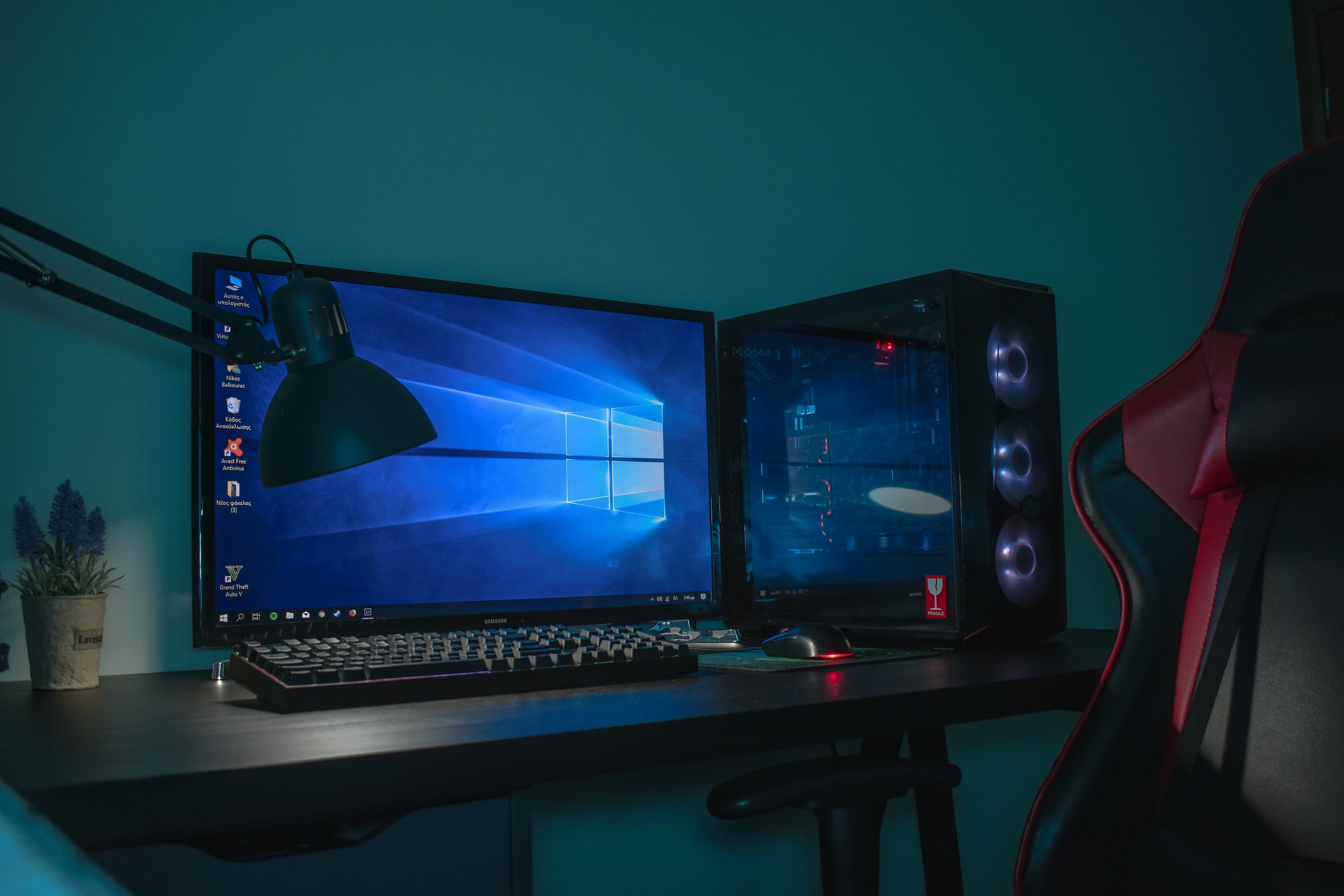 Gaming chair beside a tall RGB-lit setup