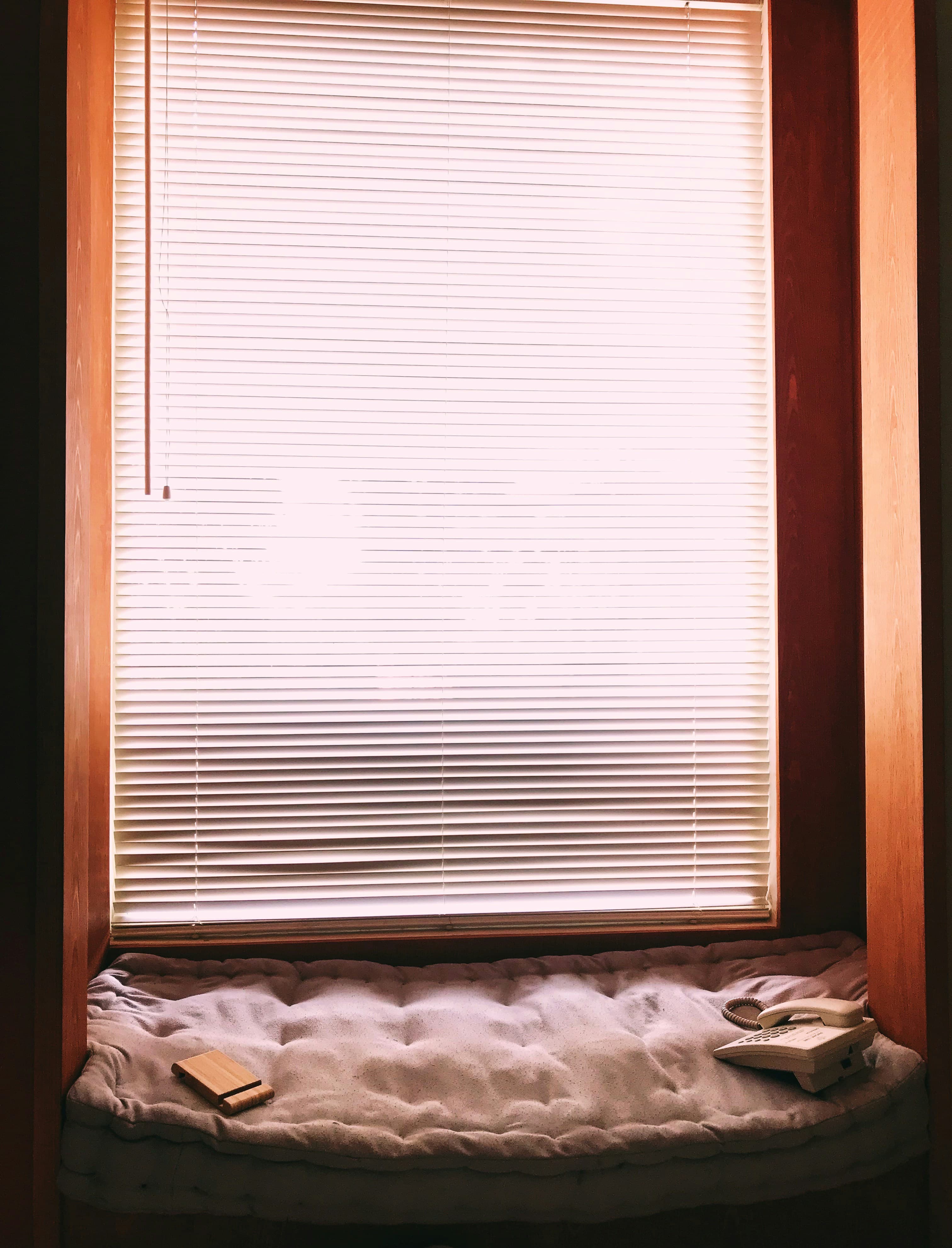 Loft 04 — natural light through wood-slat blinds