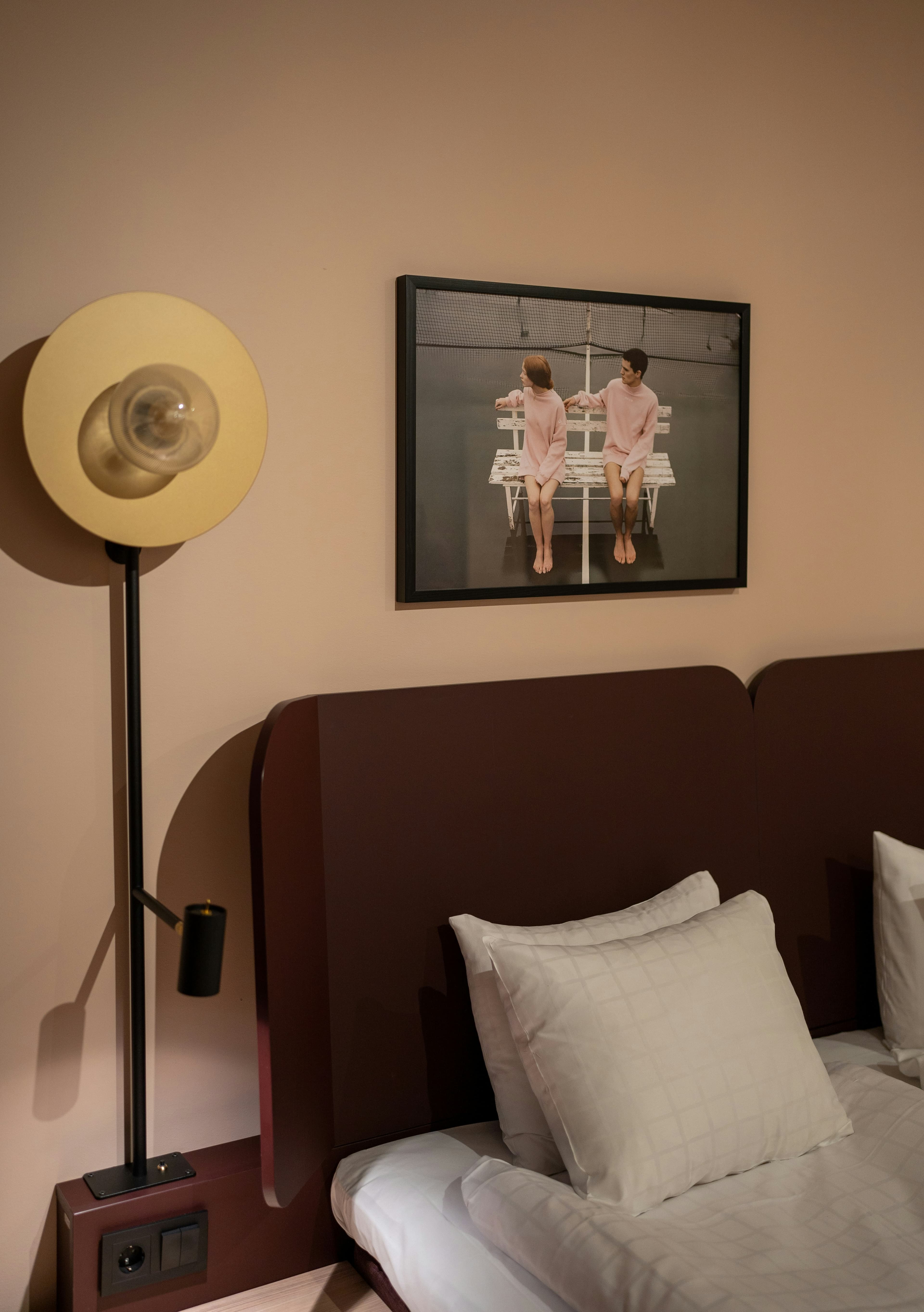 Bedside lamp on a linen-covered nightstand, morning light