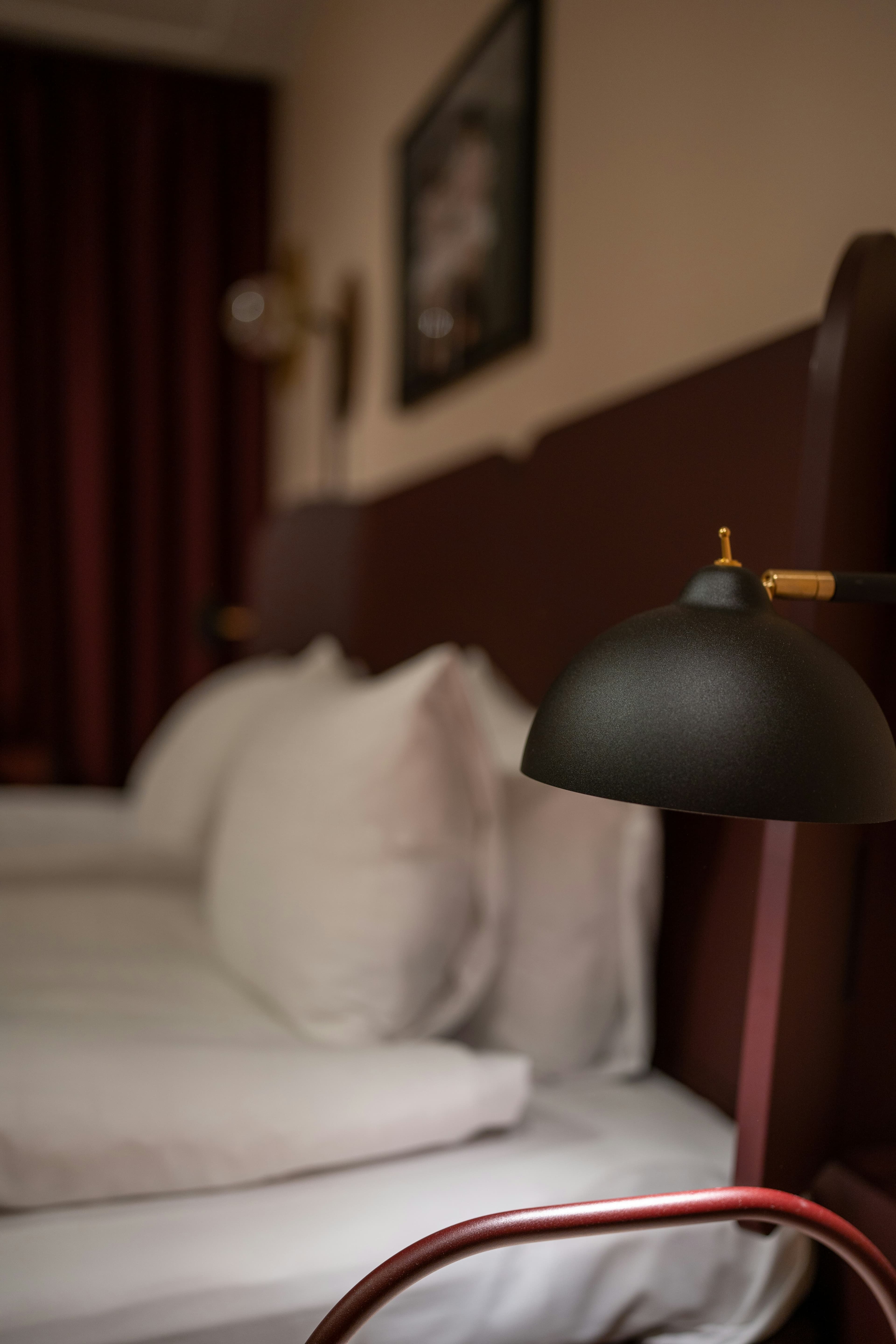 The Library Room — table lamp on a stacked-book shelf